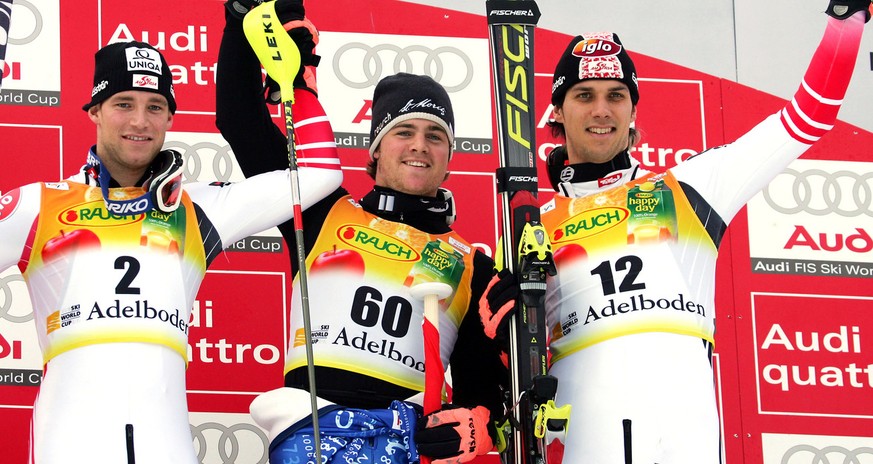 Switzerland&#039;s Marc Berthod, center, winner of the Alpine ski world Cup men&#039;s slalom race, celebrates on the podium with second placed Austria&#039;s Benjamin Raich, left, and third placed Au ...