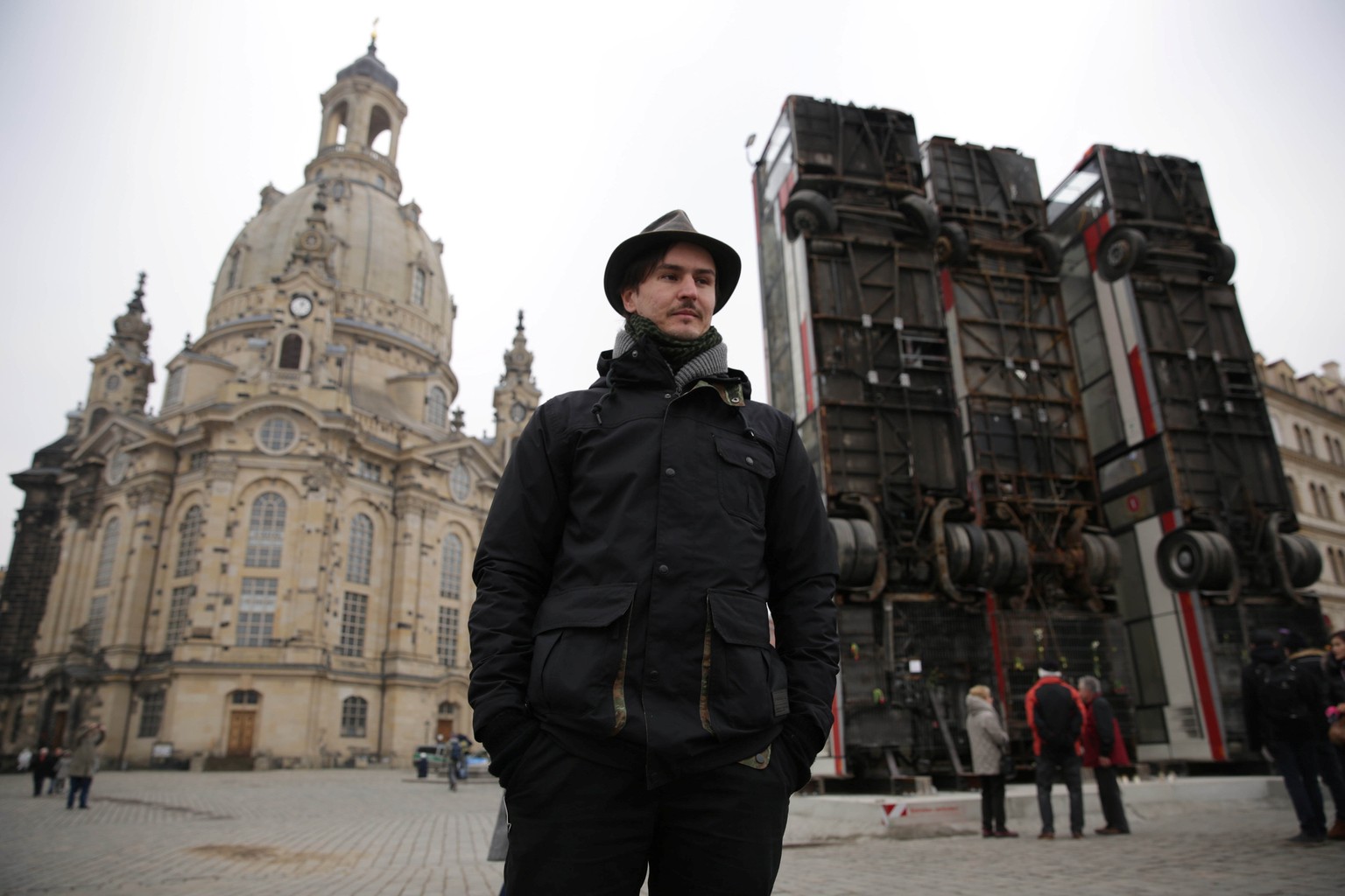 Syrian artist Manaf Halbouni stands next to his art instalation &quot;Monument&quot; made from three passenger busses near to the &#039;Frauenkirche&#039; church in Dresden, Germany February 8, 2017.  ...