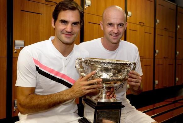 epa06481360 A handout photo made available by Tennis Australia shows Roger Federer of Switzerland posing with his trophy and his coach Ivan Ljubicic (R) in the men&#039;s locker room after winning the ...