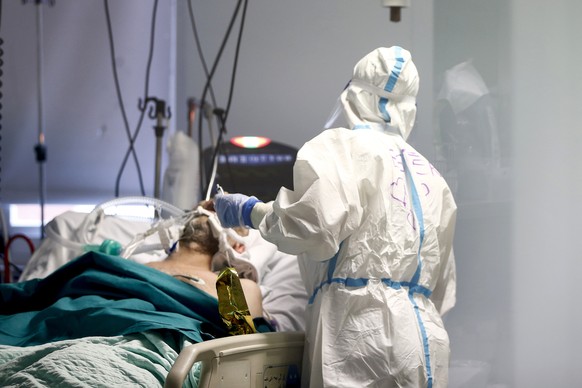 A medical staff tends to a patient inside the COVID-19 intensive care unit at the San Filippo Neri hospital in Rome, Tuesday, Nov. 3, 2020. Italy has registered its highest one-day increase in COVID-1 ...