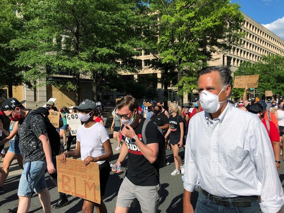 Sen. Mitt Romney, R-Utah, marches with a crowd singing &quot;Little Light of Mine&quot; in Washington on Sunday, June 7, 2020. Romney marched Sunday in the protest against police mistreatment of minor ...