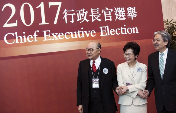 epa05871054 Hong Kong Chief Executive Election candidates Woo Kwok-hing (L), Carrie Lam Yuet-ngor (M) and John Tsang Chun-wah (R) pose for photographers on voting day during Hong Kong&#039;s Chief Exe ...