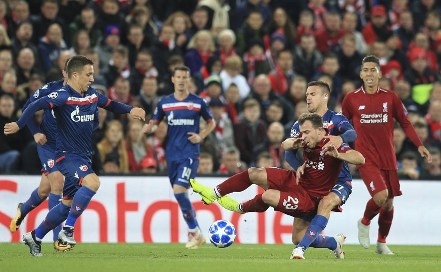 Liverpool midfielder Xherdan Shaqiri, is brought down by Red Star&#039;s Marko Marin during the Champions League group C soccer match between Liverpool and Red Star at Anfield stadium in Liverpool, En ...