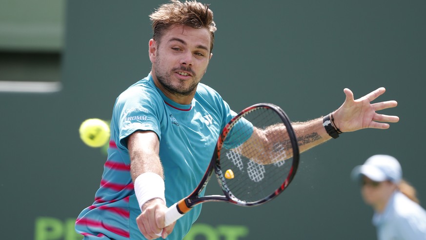 Stan Wawrinka, of Switzerland, returns a shot from Horacio Zeballos, of Argentina, during a tennis match at the Miami Open, Saturday, March 25, 2017 in Key Biscayne, Fla. (AP Photo/Wilfredo Lee)