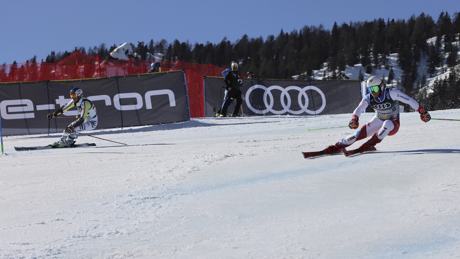 Germany&#039;s Alexander Schmid, left, and Switzerland&#039;s Semyel Bissig speed down the course during a mixed team parallel slalom, at the alpine ski World Championships, in Cortina d&#039;Ampezzo, ...