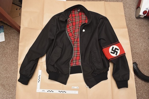 In this undated photo issued Monday Nov. 12, 2018, by Britain&#039;s West Midlands Police, showing a jacket bearing a Swastika armband found during police searches of Adam Thomas and Claudia Patatas&# ...