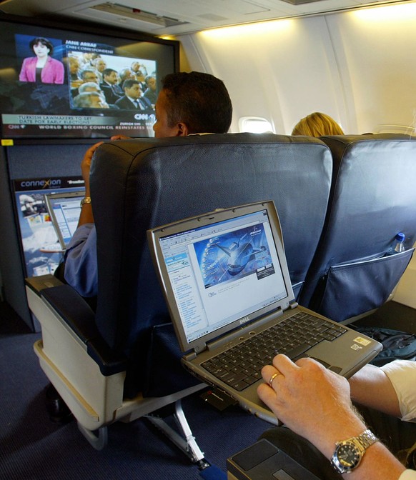 FILE - This is a July 29, 2002 file photo of a laptop is used on a plane . Britain&#039;s government Tuesday March 21, 2017 banned electronic devices in the carry-on bags of passengers traveling to th ...