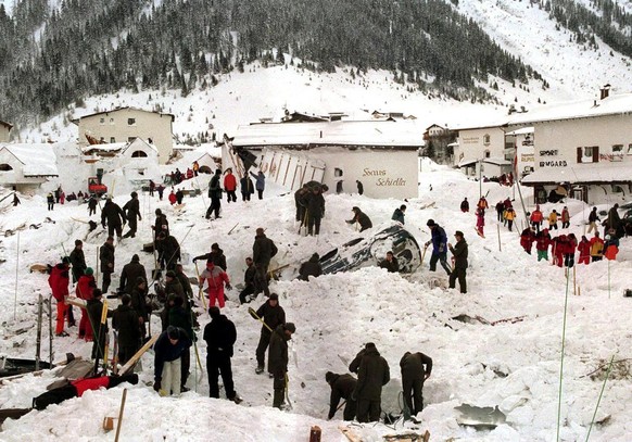 Rescue personnel shift through rubble and snow trying to reach the victims not yet found after the avalanche in Galtuer, Austria, Wednesday, February 24, 1999. Numerous roads remained closed in wester ...