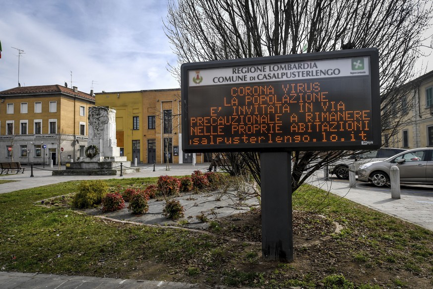 A municipality panel reads in Italian &quot; Corona Virus, as a precaution the population is invited to stay home &quot;, in Casalpusterlengo, Northern Italy, Sunday, Feb. 23, 2020. A dozen Italian to ...