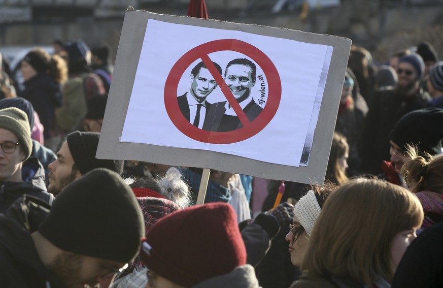 Protestors hold a poster with new Chancellor Sebastian Kern and new Vice Chancellor Heinz-Christian Strache at a demonstration during the swearing-in ceremony of the new Austrian government led by a c ...