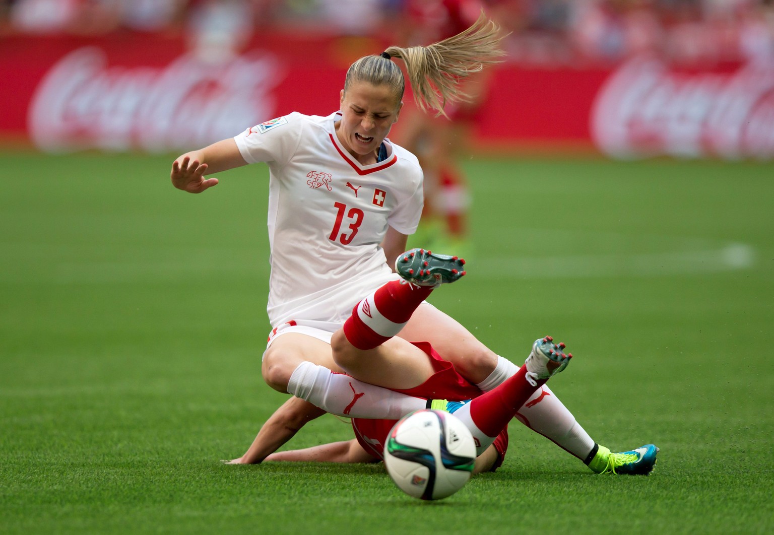 Switzerland&#039;s Ana Maria Crnogorcevic (13) and Canada&#039;s Allysha Chapman collide during the first half of the FIFA Women&#039;s World Cup soccer action in Vancouver, British Columbia, Canada,  ...