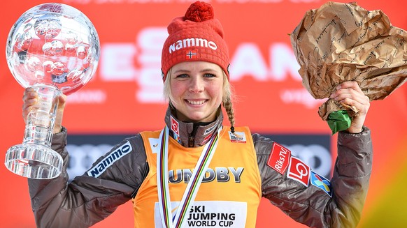 epa06628938 Maren Lundby of Norway celebrates with her crystal globe on the podium after winning the overall World Cup title following the women&#039;s FIS Ski Jumping World Cup event in Oberstdorf, G ...