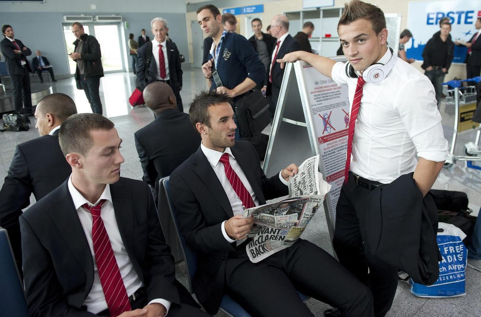 From left: Swiss national soccer team players Francois Affolter, Scott Sutter and Xherdan Shaqiri wait for their luggage at the airport in Podgorica, Montenegro, Wednesday, October 6, 2010. Switzerlan ...