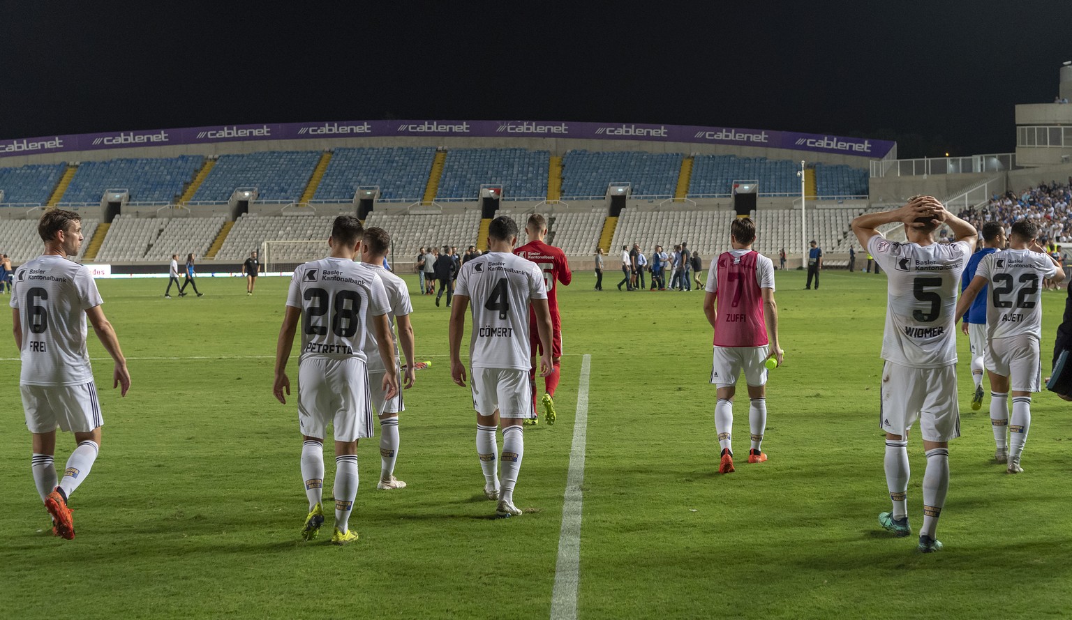 Basel&#039;s disappointed players leave the pitch after the UEFA Europa League play-off second leg match between Cyprus&#039; Apollon Limassol FC and Switzerland&#039;s FC Basel 1893 in the GSP stadiu ...