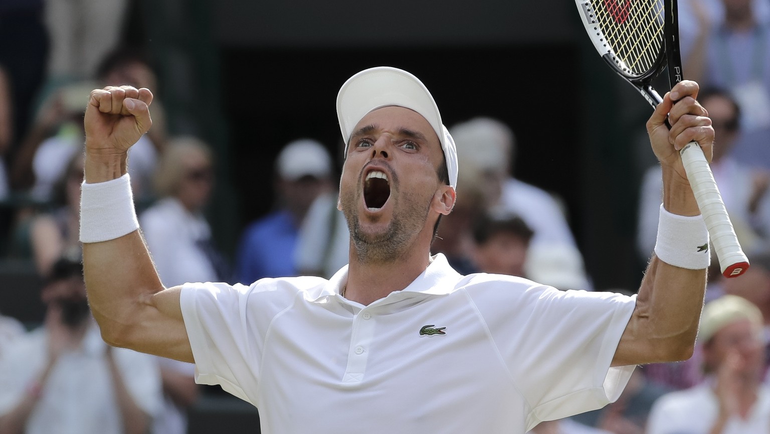 Spain&#039;s Roberto Bautista Agut celebrates winning a men&#039;s quarterfinal match against Argentina&#039;s Guido Pella on day nine of the Wimbledon Tennis Championships in London, Wednesday, July  ...
