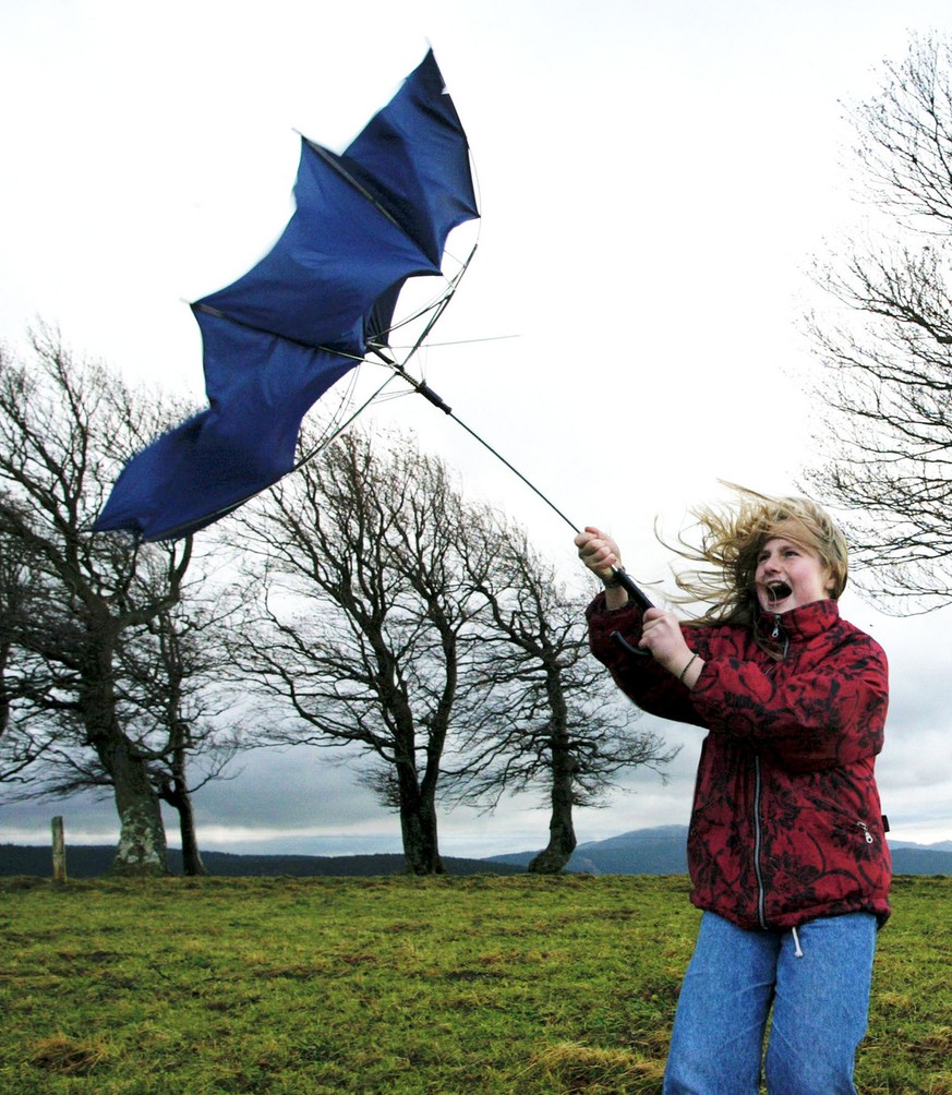 Jeanette tries to hold her umbrella as heavy storms sweep over the Schauinsland hill near Freiburg, southwestern Germany, Sunday Oct. 27, 2002. Storm winds swept across Germany on Sunday, leaving at l ...