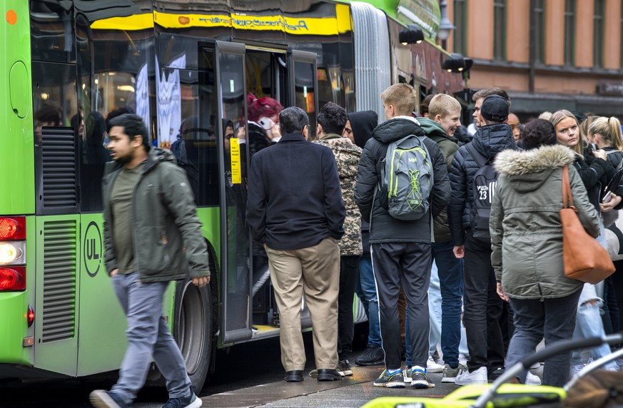 People board a local bus in central Uppsala, Sweden, Wednesday, Oct. 21, 2020. Uppsala, a university city north of Stockholm, on Tuesday became the first place in Sweden to introduce local restriction ...
