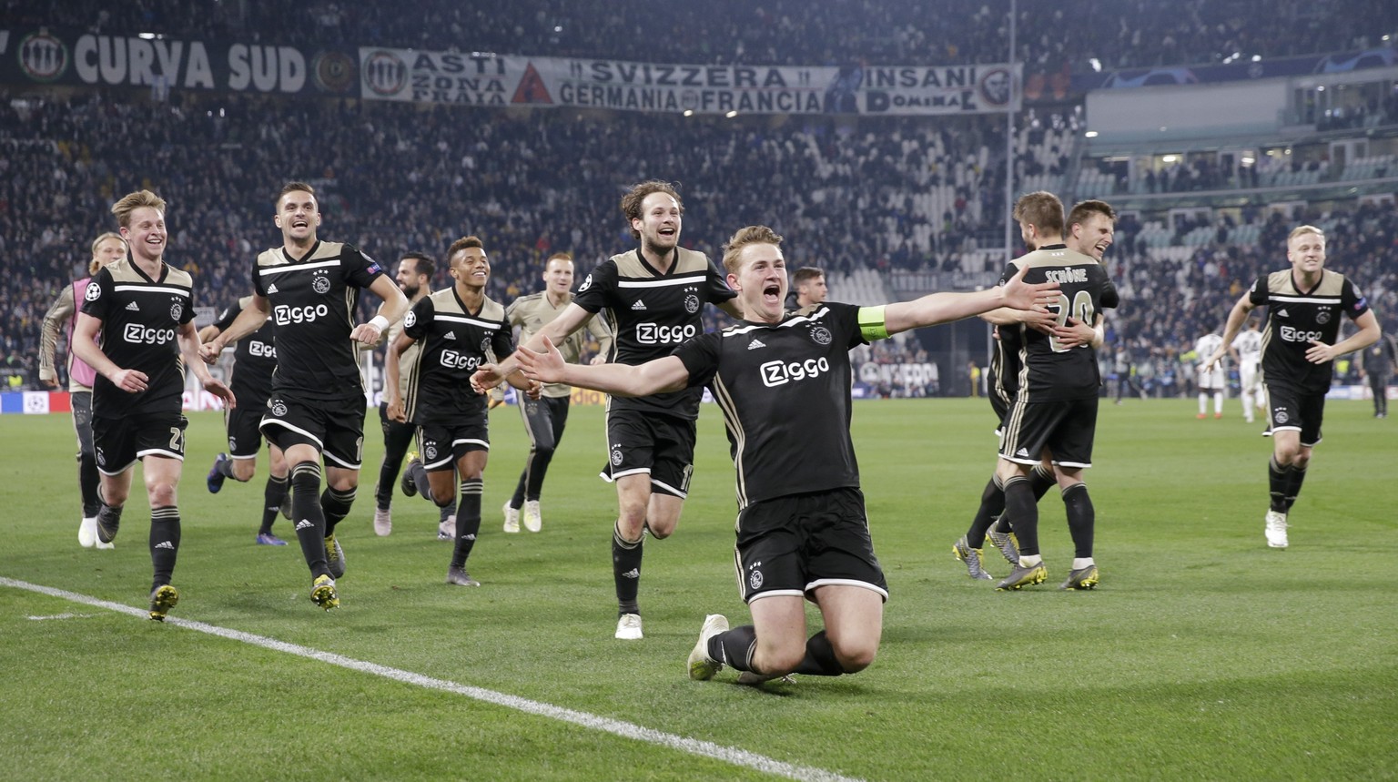 Ajax players celebrate at the end of the Champions League, quarterfinal, second leg soccer match between Juventus and Ajax, at the Allianz stadium in Turin, Italy, Tuesday, April 16, 2019. Ajax won 2- ...