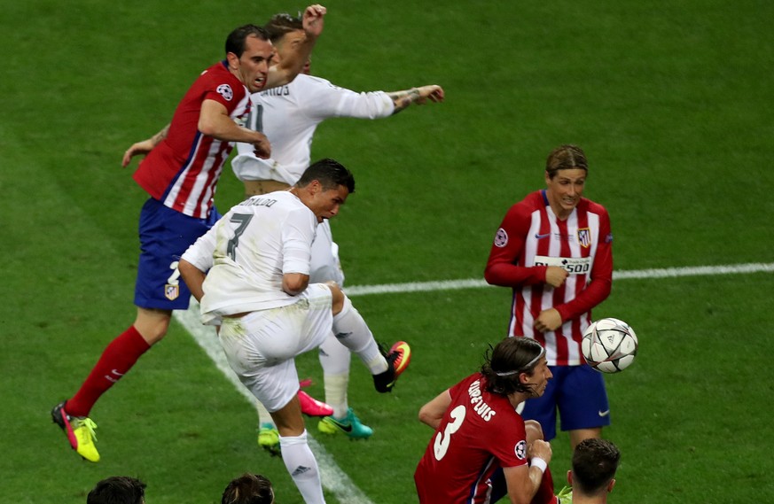 Real Madrid&#039;s Cristiano Ronaldo fights for the ball against Atletico&#039;s Fernando Torres and Filipe Luis during the Champions League final soccer match between Real Madrid and Atletico Madrid  ...
