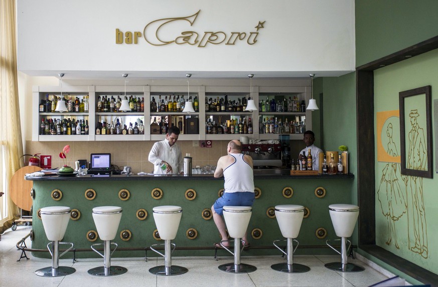 In this Sept. 12, 2017, photo, a customer sits at the lobby bar of the Hotel Capri in Havana, Cuba. New details about a string of mysterious “health attacks” on U.S. diplomats in Cuba indicate the inc ...