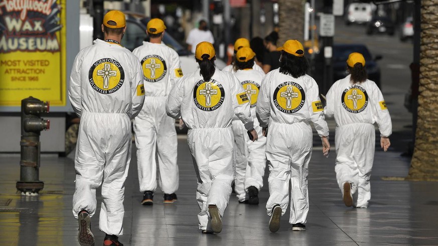 People wearing Scientology Volunteer Ministries logos walk near Hollywood and Highland during the coronavirus outbreak Thursday, May 14, 2020, in the Hollywood section of Los Angeles. (AP Photo/Mark J ...