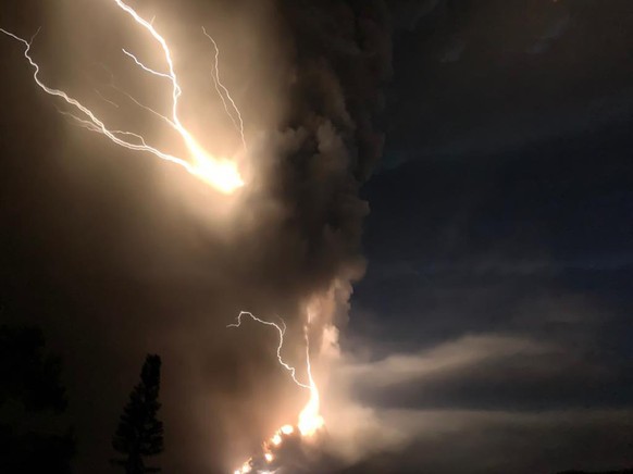 Lightning flashes as Taal Volcano erupts Sunday Jan. 12, 2020, in Tagaytay, Cavite province, outside Manila, Philippines. A tiny volcano near the Philippine capital that draws many tourists for its pi ...