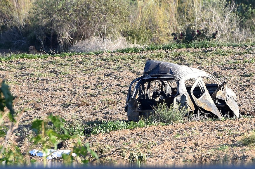 The wreckage of the car of investigative journalist Daphne Caruana Galizia lies next to a road in the town of Mosta, Malta, Monday, Oct. 16, 2017. Malta&#039;s prime minister says a car bomb has kille ...