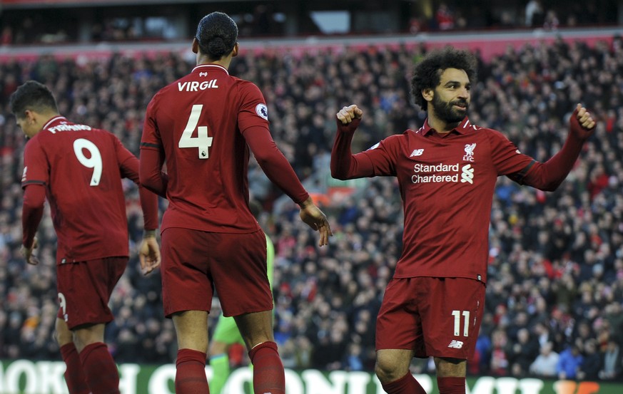 Liverpool&#039;s Mohamed Salah, right, celebrates after scoring his side&#039;s third goal during the English Premier League soccer match between Liverpool and AFC Bournemouth at Anfield stadium in Li ...