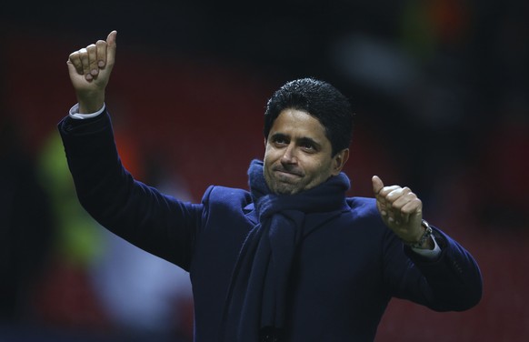 Paris Saint Germain owner Nasser bin Ghanim Al-Khelaifi waves to his teams fans after the end of the Champions League round of 16 soccer match between Manchester United and Paris Saint Germain at Old  ...