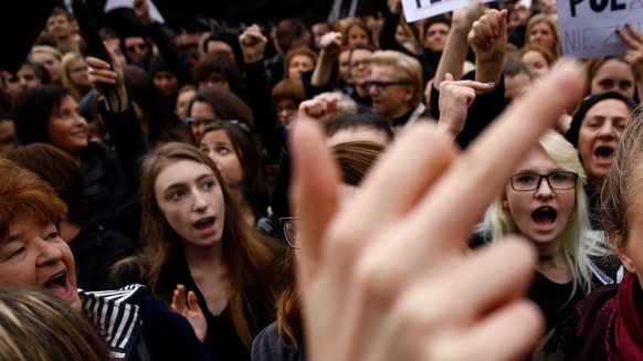 A woman gestures as people gather in an abortion rights campaigners&#039; demonstration to protest against plans for a total ban on abortion in front of the ruling party Law and Justice (PiS) headquar ...