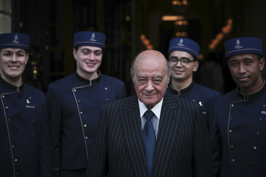Egyptian businessman and Ritz owner Mohammed Al Fayed poses with his hotel staff for a photograph, in Paris, Monday, June 27, 2016, as guests gather for the inauguration of the newly renovated Place V ...