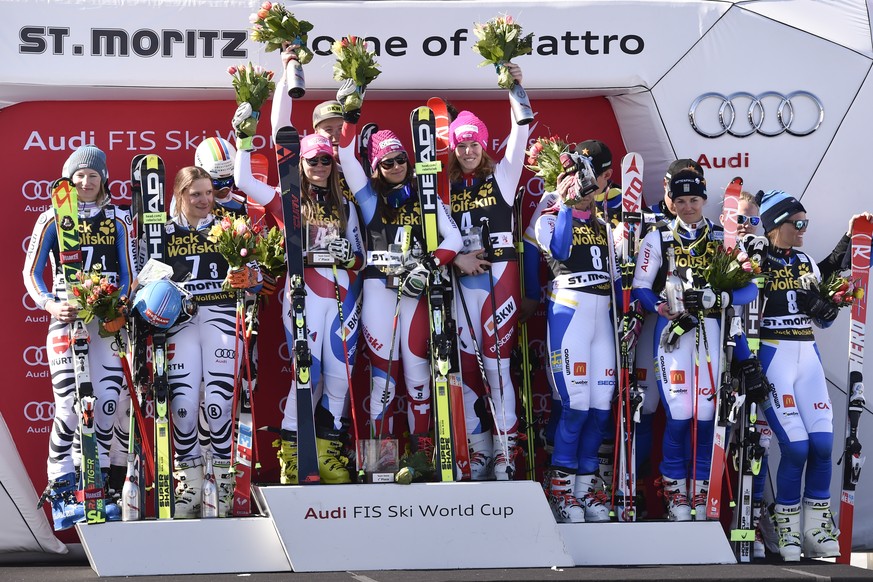 Second placed Team Germany, first placed Team Switzerland and third placed Team Sweden, from left, pose after the Nation Team Event race at the FIS Alpine Ski World Cup Finals, in St. Moritz, Switzerl ...