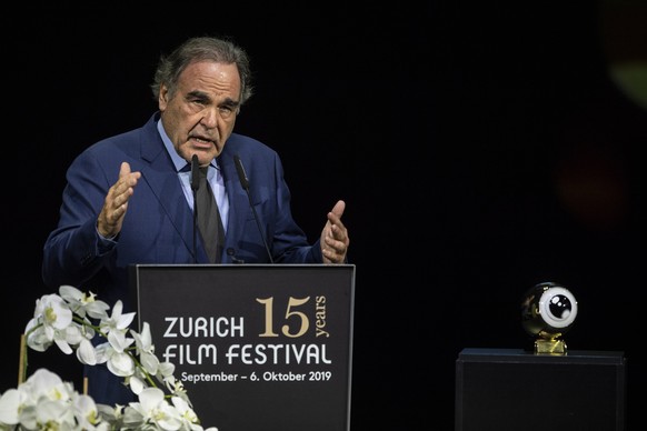 epa07899654 American filmmaker Oliver Stone speaks during the Award Night ceremony of the 15th Zurich Film Festival (ZFF) in Zurich, Switzerland, 05 October 2019. The festival runs from 26 September t ...
