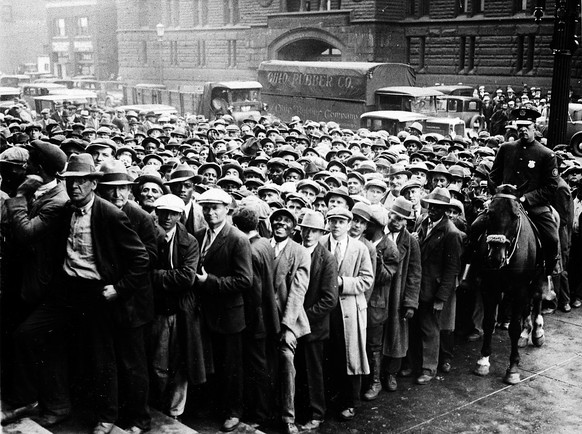 FILE - In this Oct. 9, 1930 file photo, thousands of unemployed people gather outside City Hall in Cleveland during the Great Depression, after some 2,000 jobs were made available for park improvement ...