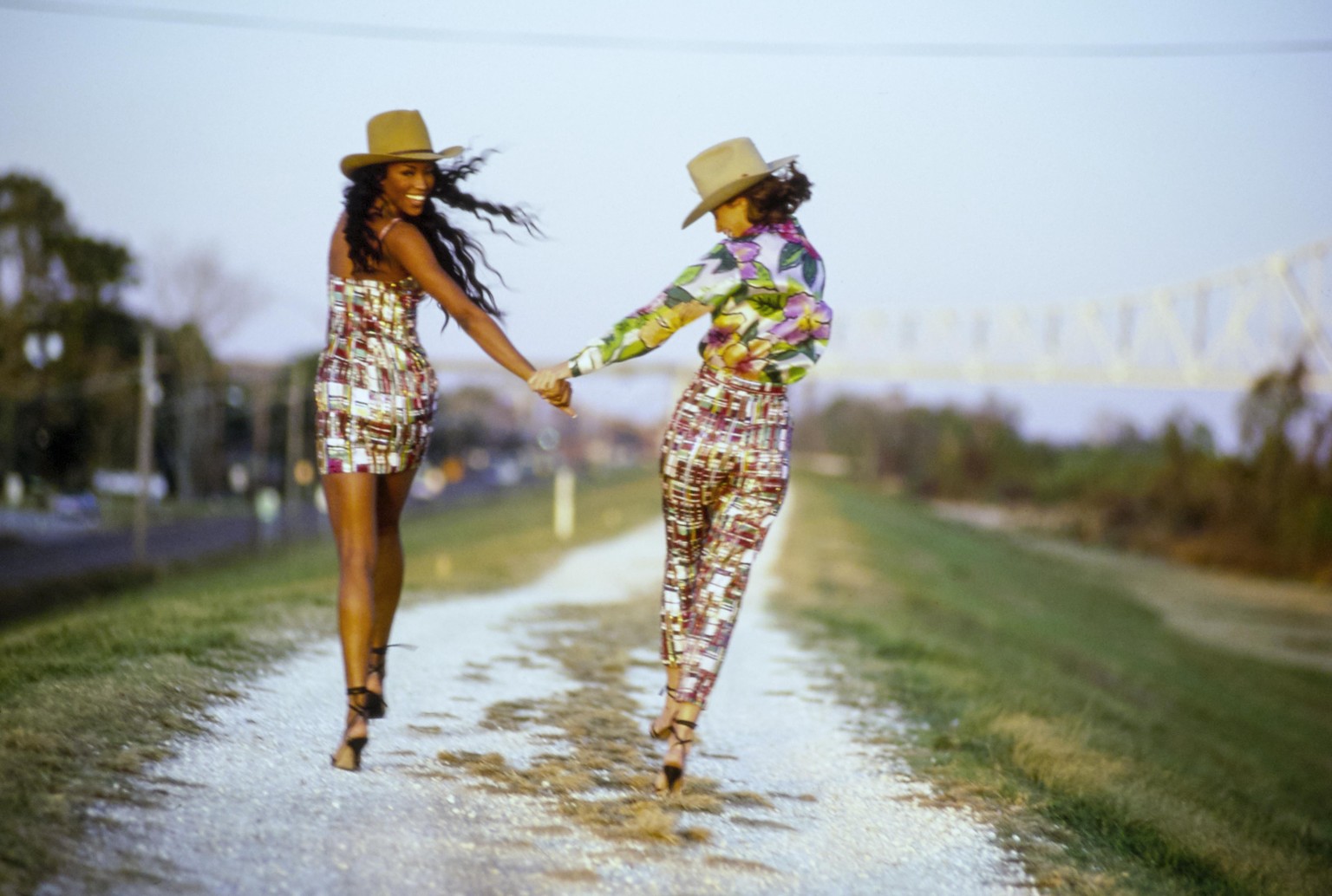 UNITED STATES - FEBRUARY 1: Models, Naomi Campbell (left) and Christy Turlington walking down road wearing patterned outfits by Todd Oldham CREDIT MUST READ: Arthur Elgort/Conde Nast via Getty Images. ...