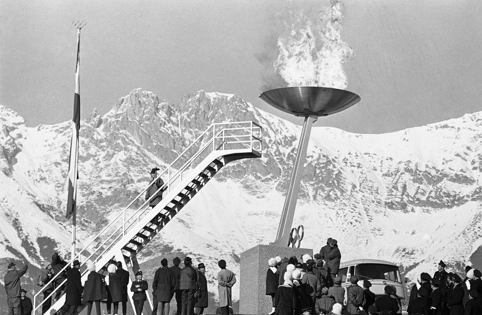 Flames and smoke soar up with a “whoosh” as the Olympic flame is lit at the top of the Olympic Stadium at Innsbruck, Austria on Jan. 21, 1964. The lighting was part of the first rehearsal for the open ...