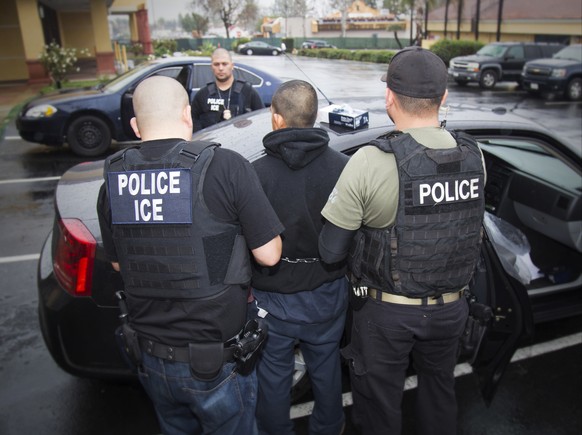 FILE - In this Feb. 7, 2017, file photo released by U.S. Immigration and Customs Enforcement, foreign nationals are arrested during a targeted enforcement operation conducted by U.S. Immigration and C ...