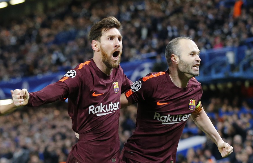 Barcelona&#039;s Lionel Messi celebrates with Andres Iniesta scoring his side&#039;s first goal during a Champions League round of sixteen first leg soccer match between FC Barcelona and Chelsea at St ...