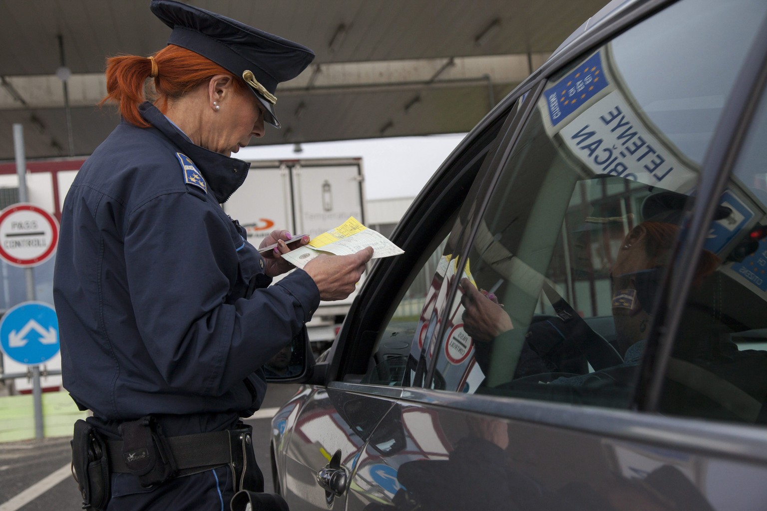epa05893945 A Hungarian border police officer checks the travel documents of motorists on the first day more stringent provisions of the Schengen Borders Code are applied, at the Hungarian-Croatian bo ...