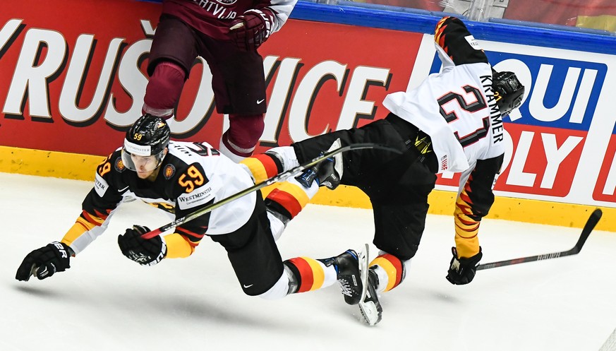 epa06729917 Manuel Wiederer (L) of Germany and Nicolas Krammer (R) of Germany in action during the IIHF World Championship group B ice hockey match between Latvia and Germany in Jyske Bank Boxen in He ...