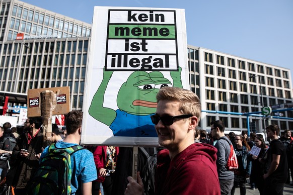 epa07458116 A protestor holds a banner reading &#039;No meme is illegal&#039; during the &#039;Save The Internet&#039; demonstration in Berlin, Germany, 23 March, 2019. The demonstrators are protestin ...