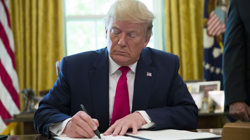 President Donald Trump signs an executive order to increase sanctions on Iran, in the Oval Office of the White House, Monday, June 24, 2019, in Washington. (AP Photo/Alex Brandon)
Donald Trump