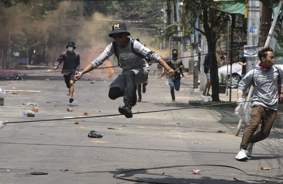 FILE - In this March 31, 2021, file photo, anti-coup protesters run away from military forces during a demonstration in Yangon. The military takeover of Myanmar early in the morning of Feb. 1 reversed ...