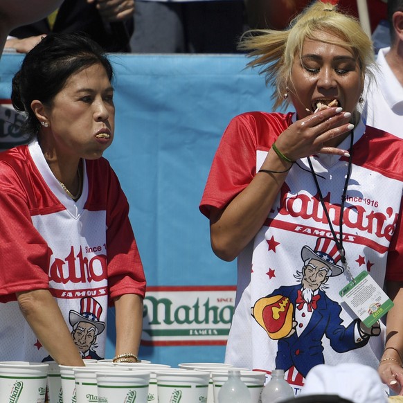 Juliet Lee, left, and Miki Sudo, right, compete in the women&#039;s competition of Nathan&#039;s Famous July Fourth hot dog eating contest, Thursday, July 4, 2019, in New York&#039;s Coney Island. (AP ...