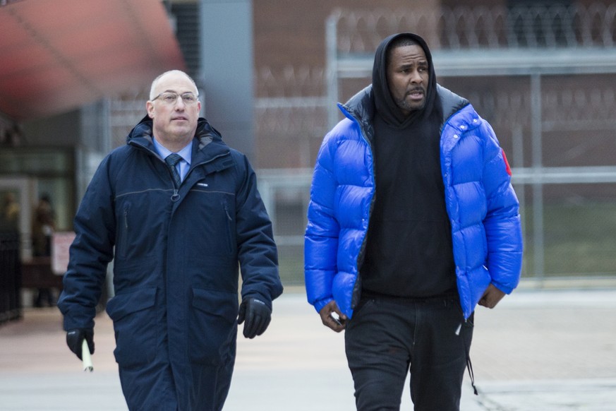 FILE - In this Monday, Feb. 25, 2019 file photo, R. Kelly walks out of Cook County Jail with his defense attorney, Steve Greenberg, after posting $100,000 bail, in Chicago. In his first interview sinc ...