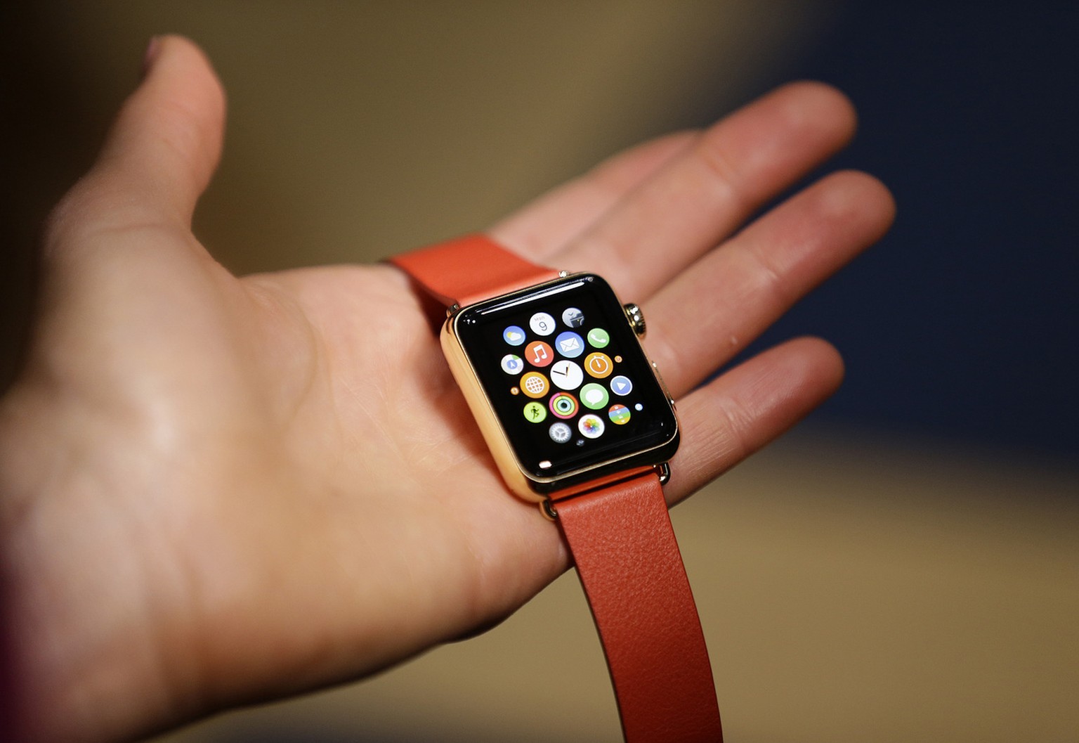 A woman holds the Apple Watch Edition during a demo following an Apple event Monday, March 9, 2015, in San Francisco. Make calls, read email, control music, manage Instagram photos, keep up with your  ...