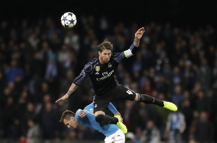 Real Madrid&#039;s Sergio Ramos falls on Napoli&#039;s Nikola Maksimovic during the Champions League round of 16, second leg, soccer match between Napoli and Real Madrid at the San Paolo stadium in Na ...
