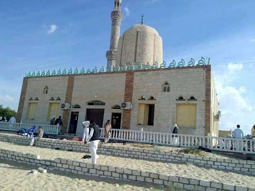 epa06347846 People walk outside a mosque that was attacked in the northern city of Arish, Sinai Peninsula, Egypt, 24 November 2017. According to initial reports, dozens were killed and injured in a bo ...
