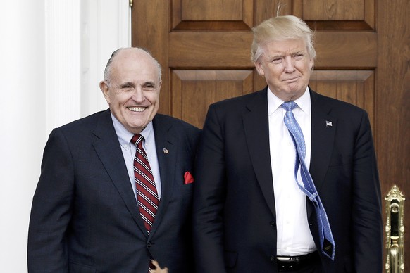 epa07883526 (FILE) - Former New York City Mayor Rudy Giuliani (L) poses with US President Donald J. Trump at the clubhouse of Trump International Golf Club, in Bedminster Township, New Jersey, USA, 20 ...