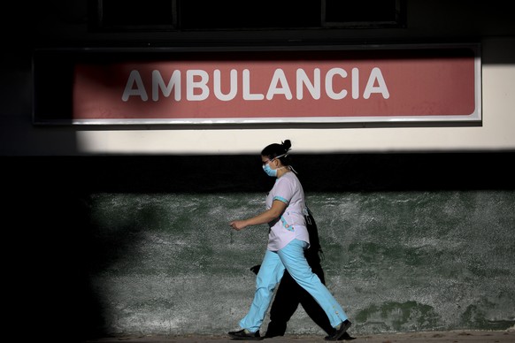 A heath worker walks outside the Manuel Belgrano public hospital on the outskirts of Buenos Aires, Argentina, Friday, April 17, 2020. Argentina confirmed a coronavirus outbreak at this hospital where  ...